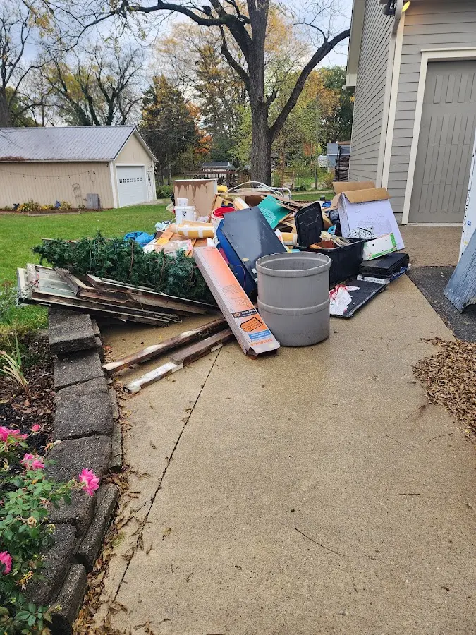 Dumpster being loaded with debris for 12 Yard Dumpster Rental in Woonsocket